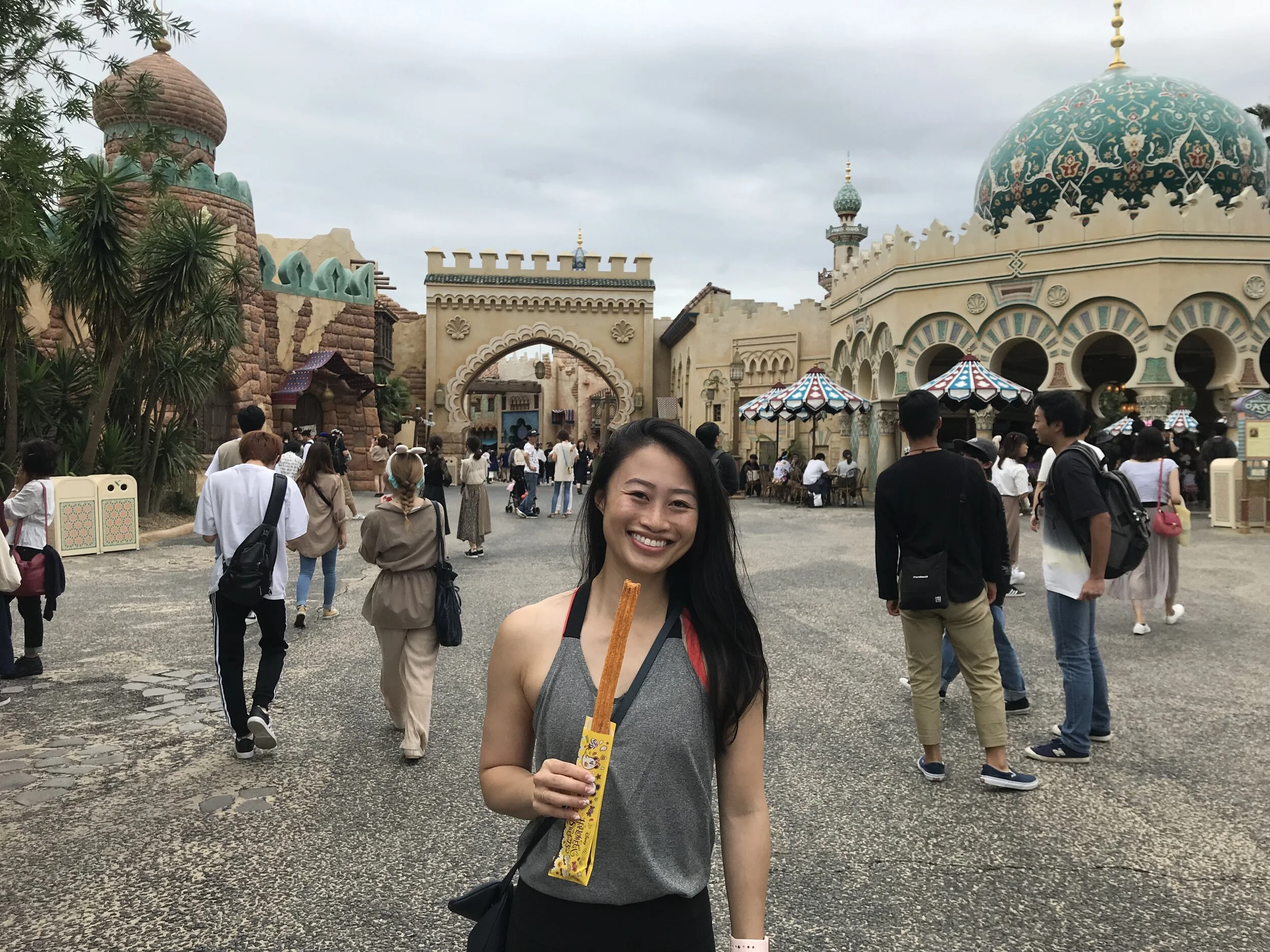 Eating a pumpkin churro (for Halloween) at Disney Sea