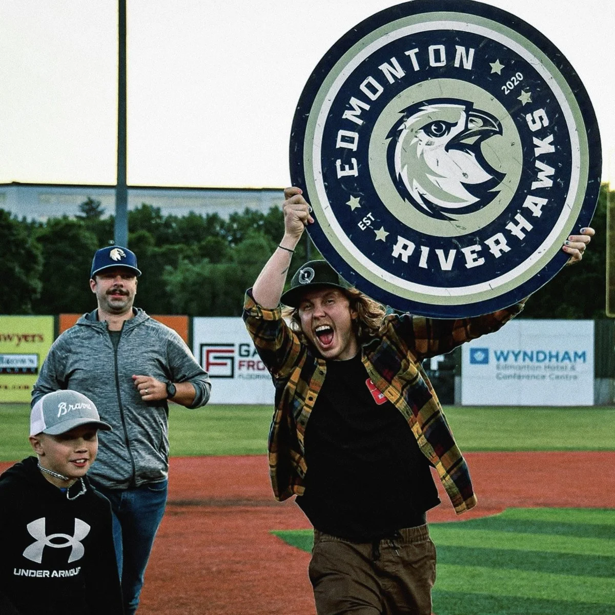 Fan celebrating with logo, design by Edmonton graphic designer Nigel Hood