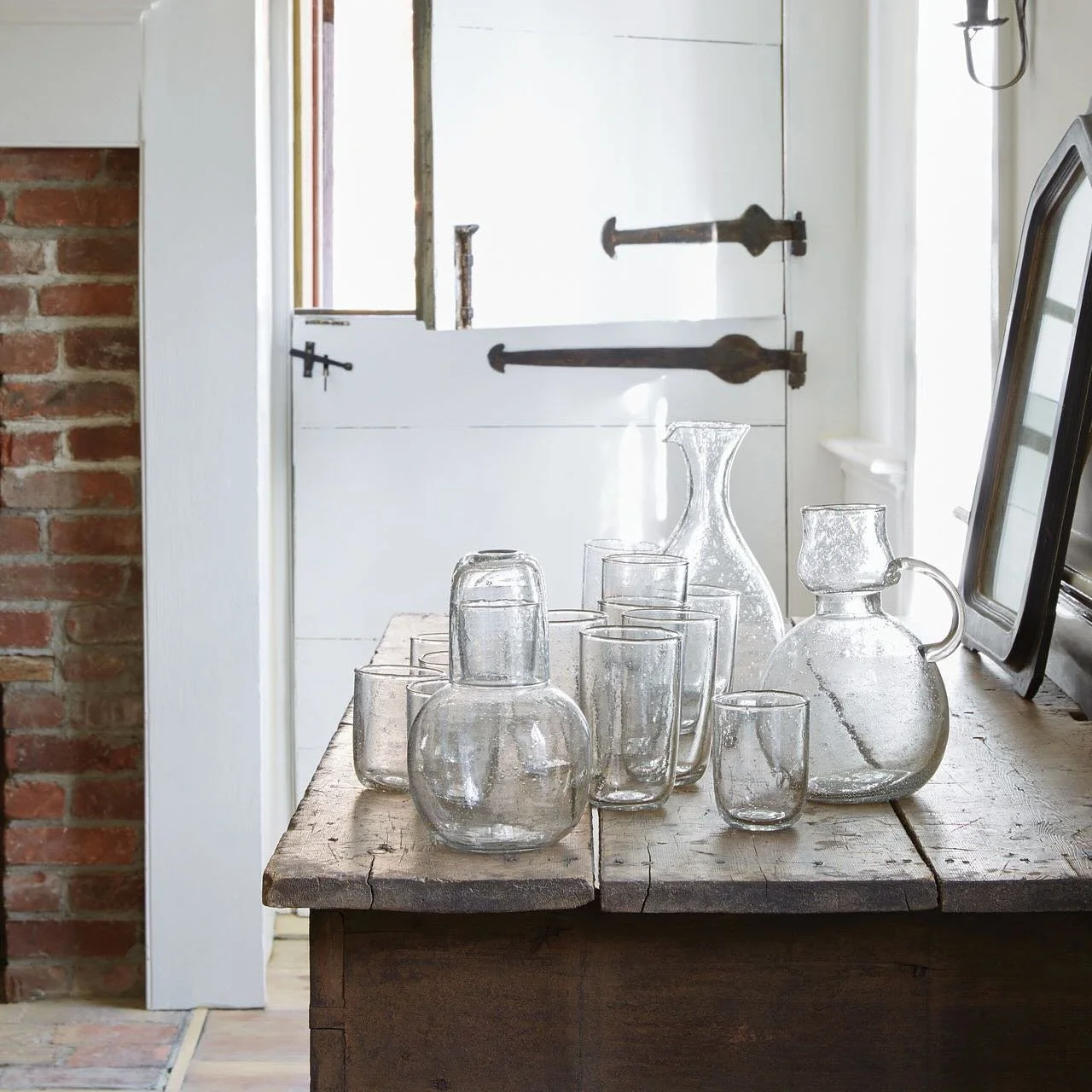 The recycled seeded glass carafe and glass is the perfect addition to a nightstand, dining table or desk.