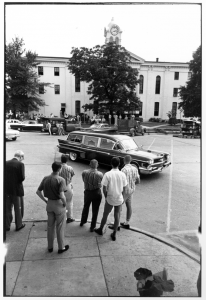  Martin J. Dain  Faulkner’s World, Oxford, Mississippi, 1961-1963  (Watching Faulkner’s Hearse Drive By the Oxford Square)  Gelatin silver, 16 x 20”  Signed 