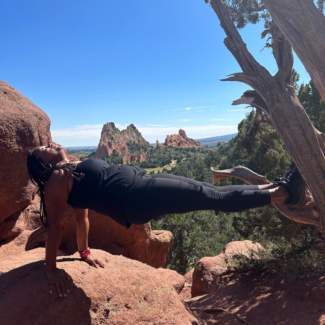 Amidst the awe-inspiring rocks of Garden of the Gods in Denver, CO, I find myself suspended in a reverse plank, a physical manifestation of the balance I strive for in both my roles as a financial coach and a yoga instructor. As the year draws to a c