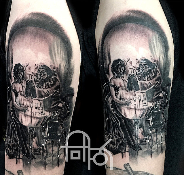 Black and Gray Clowns Having Dinner Inside a Skull Tattoo