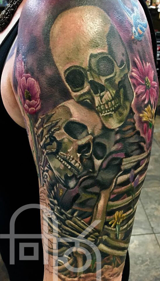 Embracing Skeletons Surrounded by Flowers Tattoo