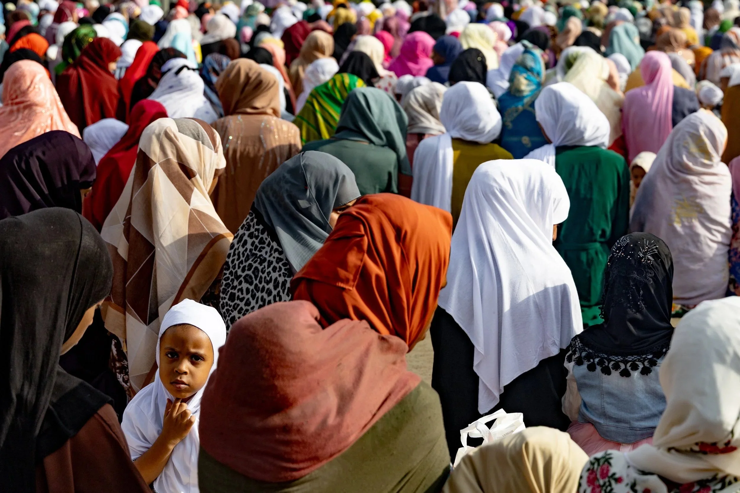  A girl looks up in the middle of prayer during Eid-Al-adha in Addis Ababa, Ethiopia on June 5, 2025. 