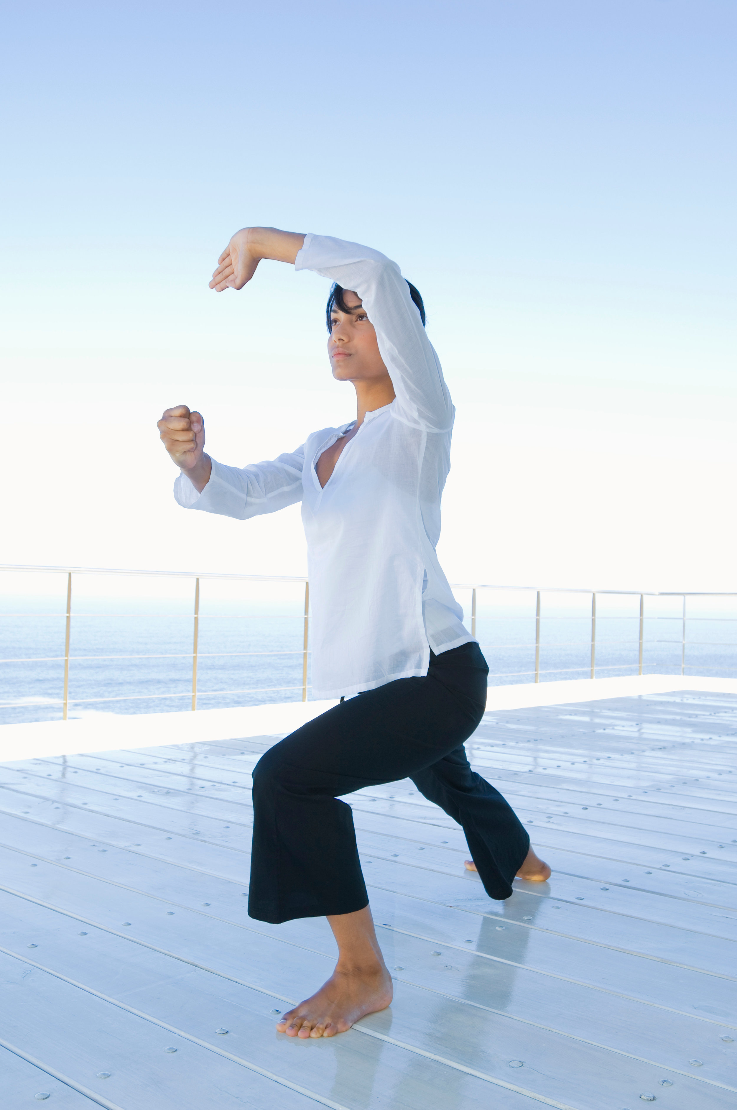 Canva - Woman practicing Tai Chi on deck (1).jpg