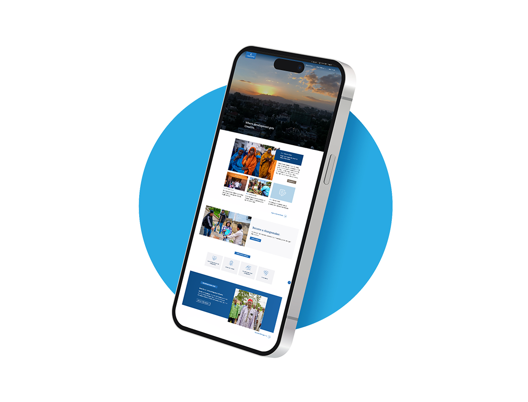 Smartphone displaying a website with images of sunset, people in colorful traditional clothing, and a news section, placed in front of a blue circular background.