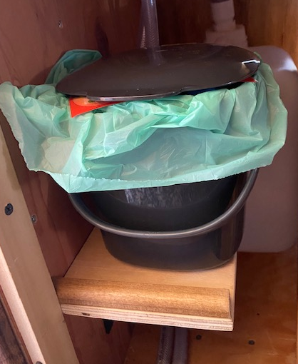  The garbage can was in the way of the sink foot pump and the laundry hamper stool, so Doug built it a little shelf. 