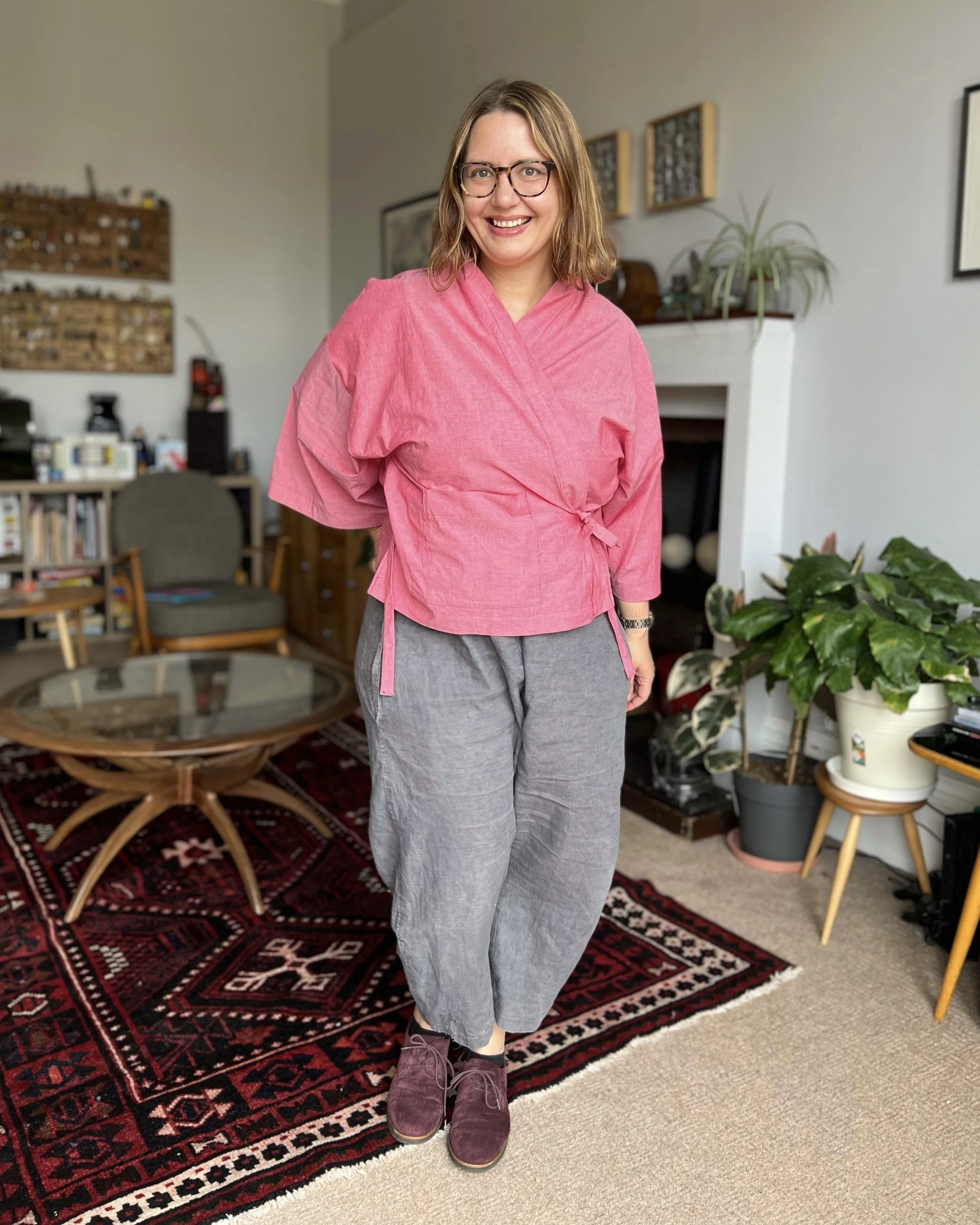 Franca wears the Papercut Patterns Luna jacket, a wrap front jacket/top with loose fitting grown on sleeve, in a red cotton chambray fabric