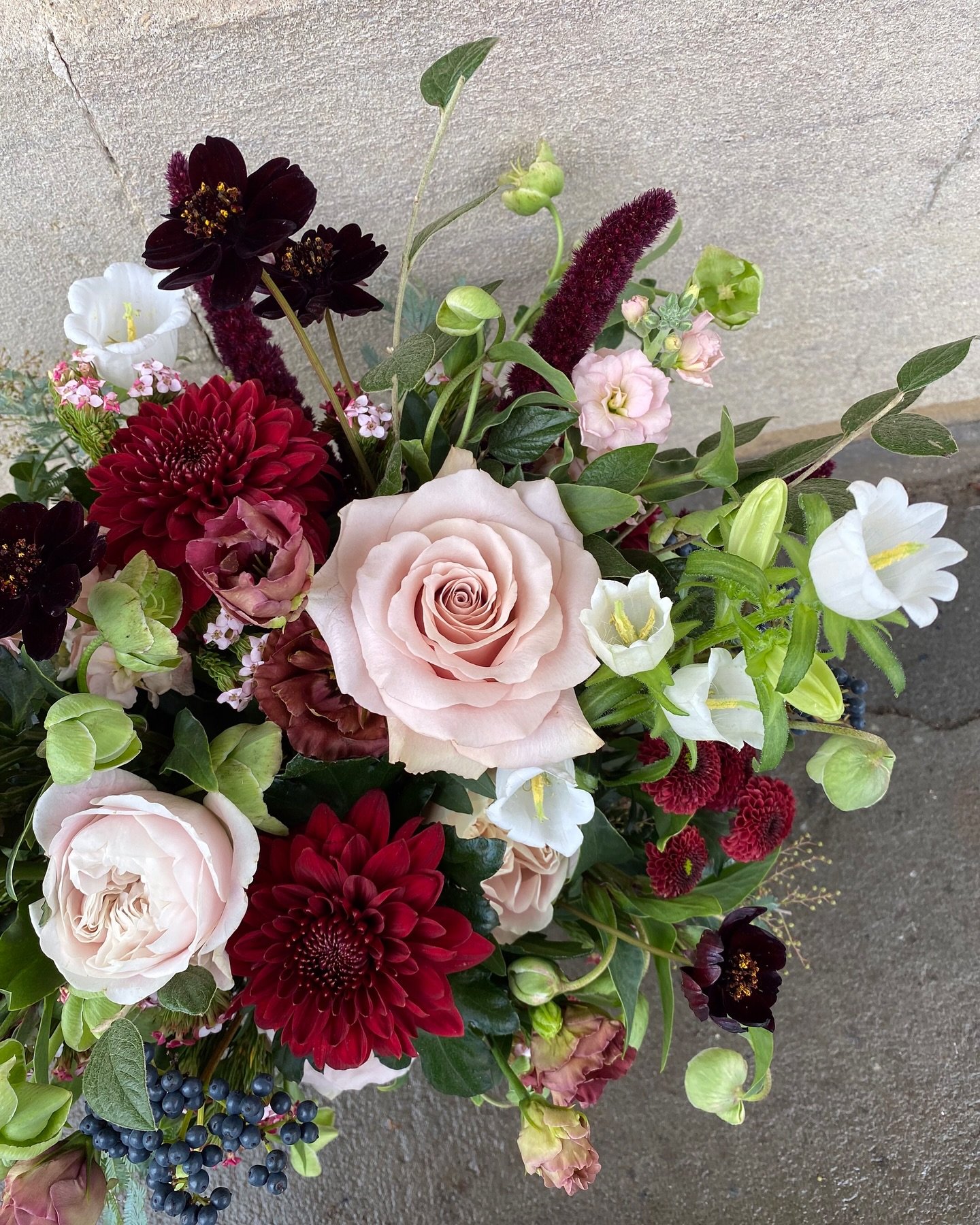 We&rsquo;re often asked how to embrace the dark jewel tones of winter without making the wedding feel too Christmassy. Here we have mixed romantic blush tones with gorgeous rich velvet red tones to give a beautifully romantic feel to the floral arran