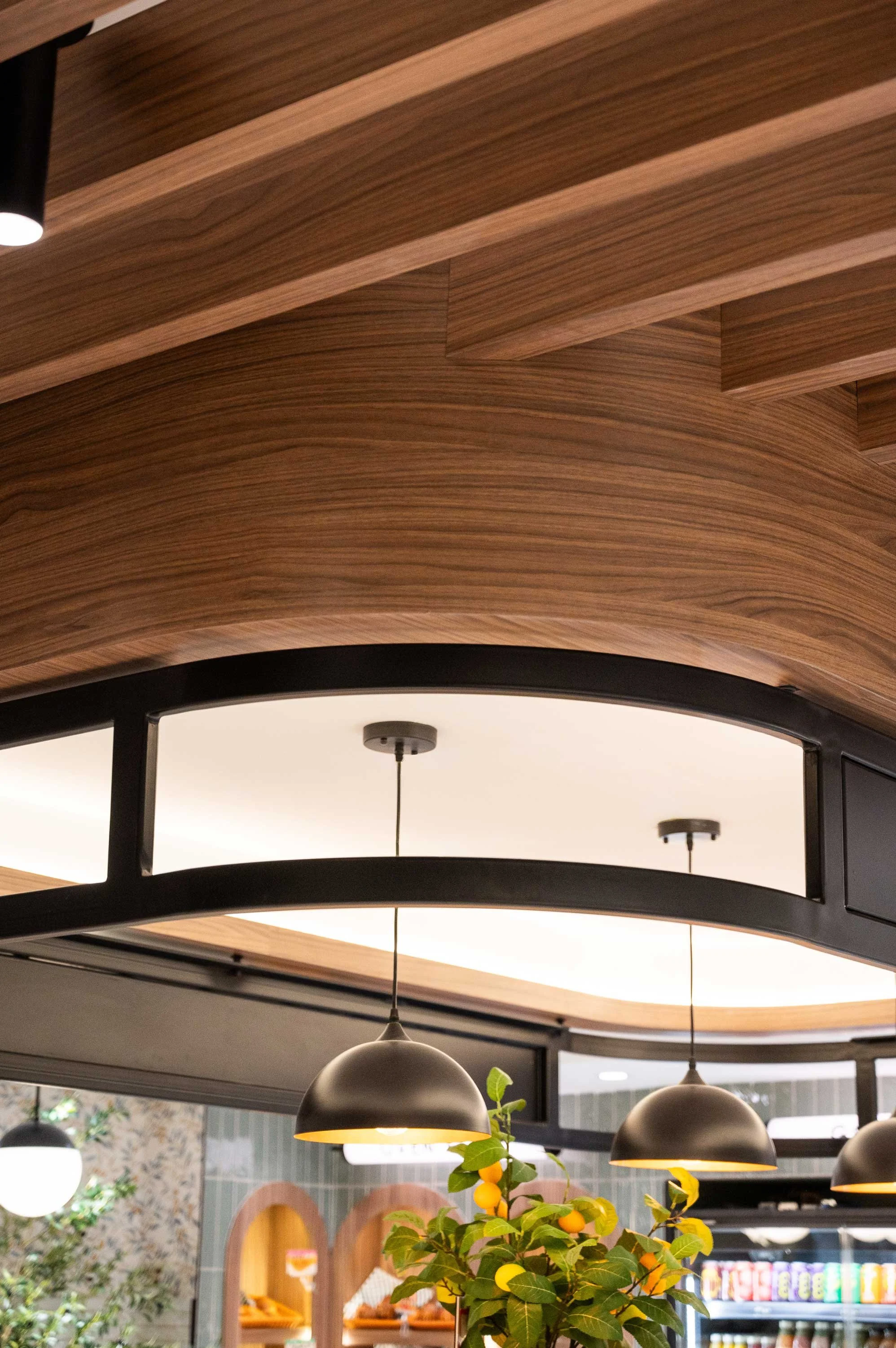 walnut wood bulkhead with black metal details and feature pendant lighting