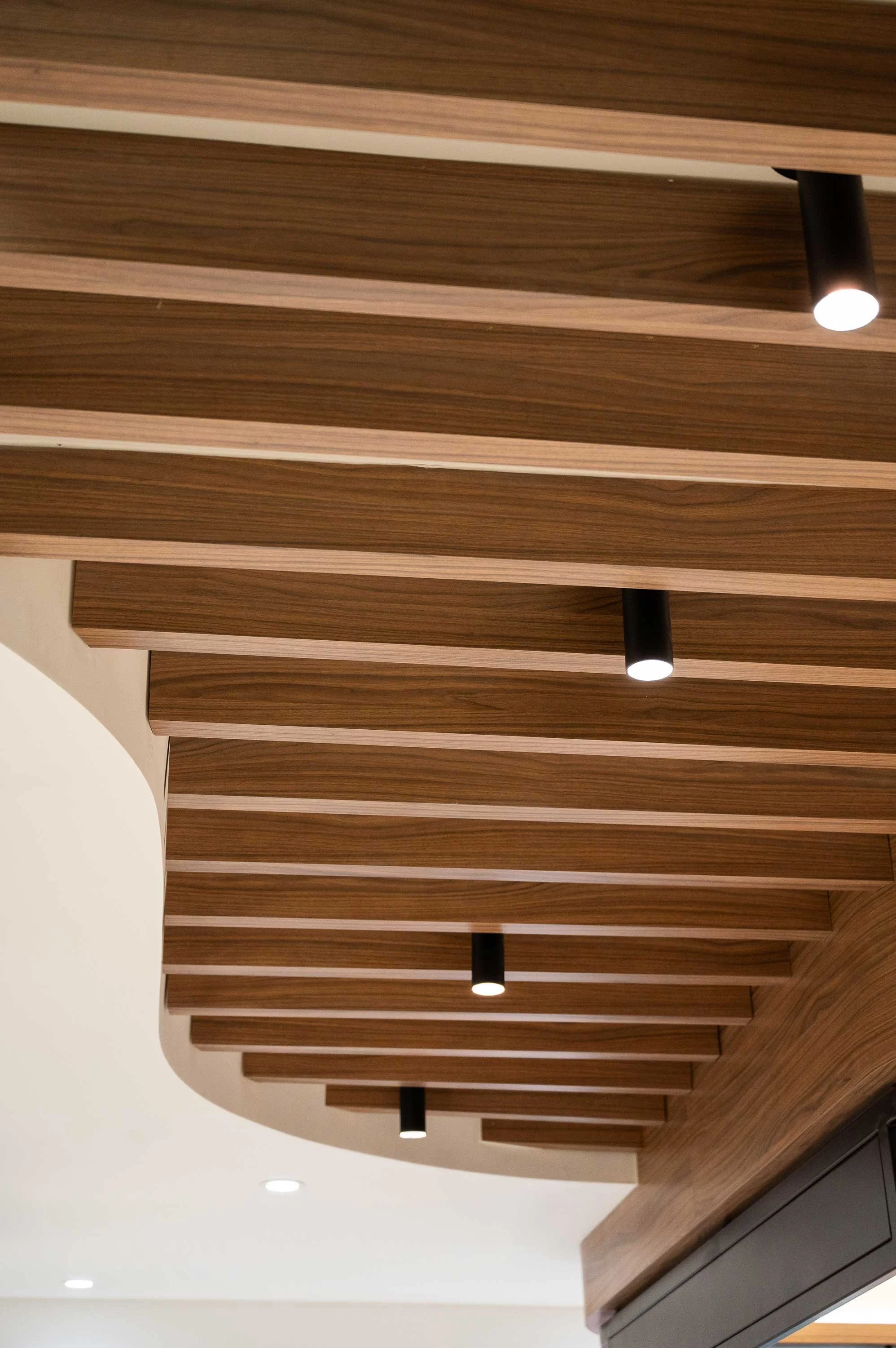 Curved bulkhead with walnut slats