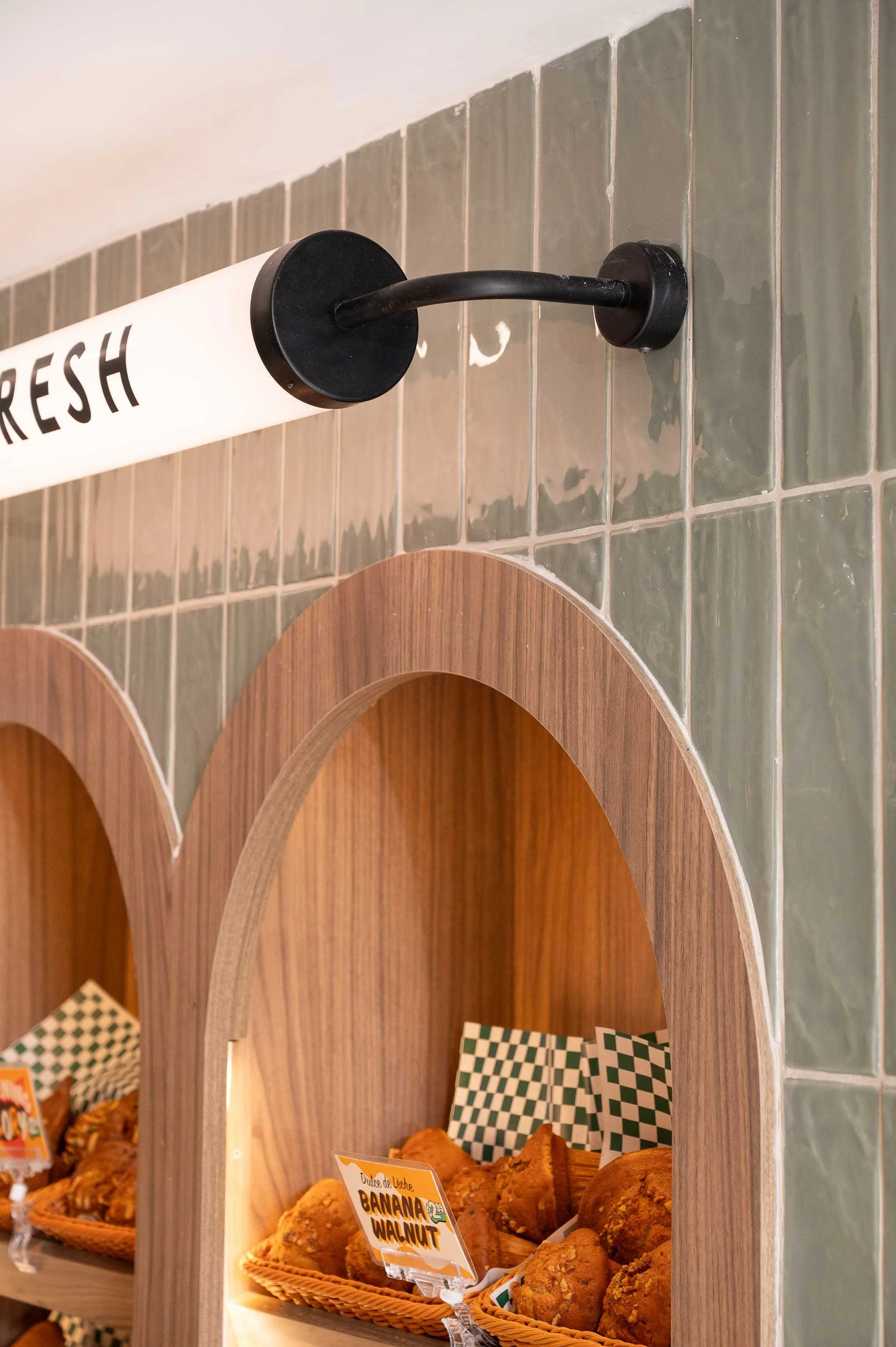 Light walnut wood arched detail for bakery display