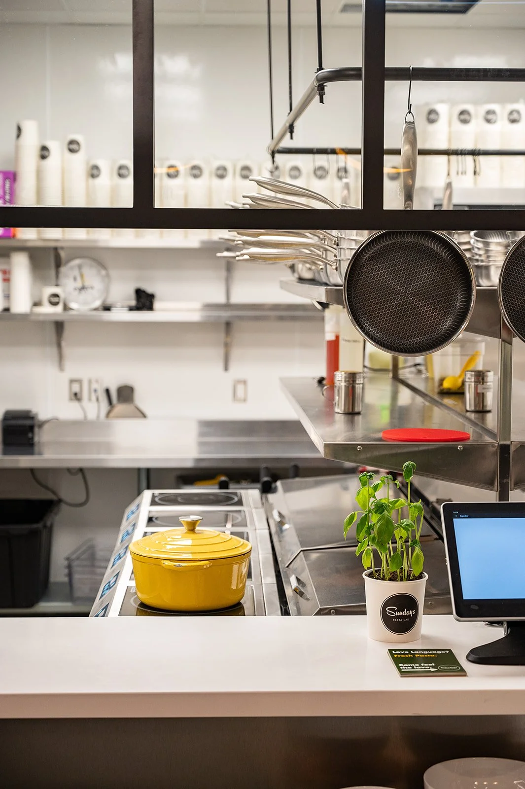 Industrial style pasta restaurant with yellow put on cooktop
