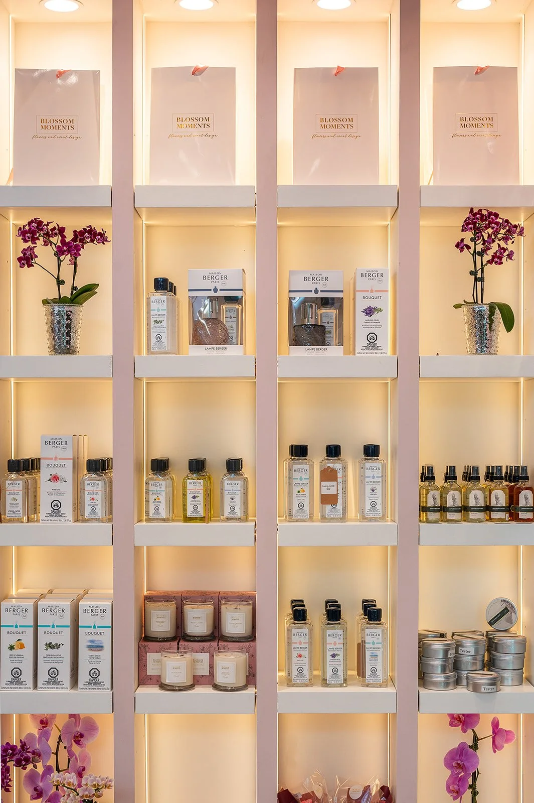Built-in retail shelving displaying candles and product bottles at Blossom Moments Scotia Plaza