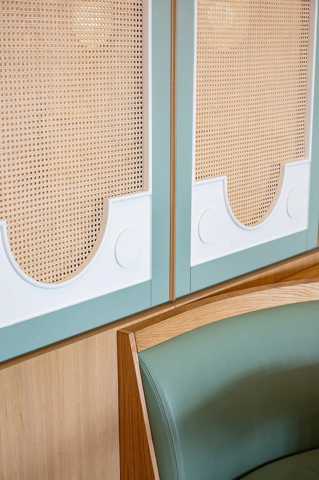 Restaurant interior detail featuring textured wall panels, wood finishes, and soft color palette in Oakville design