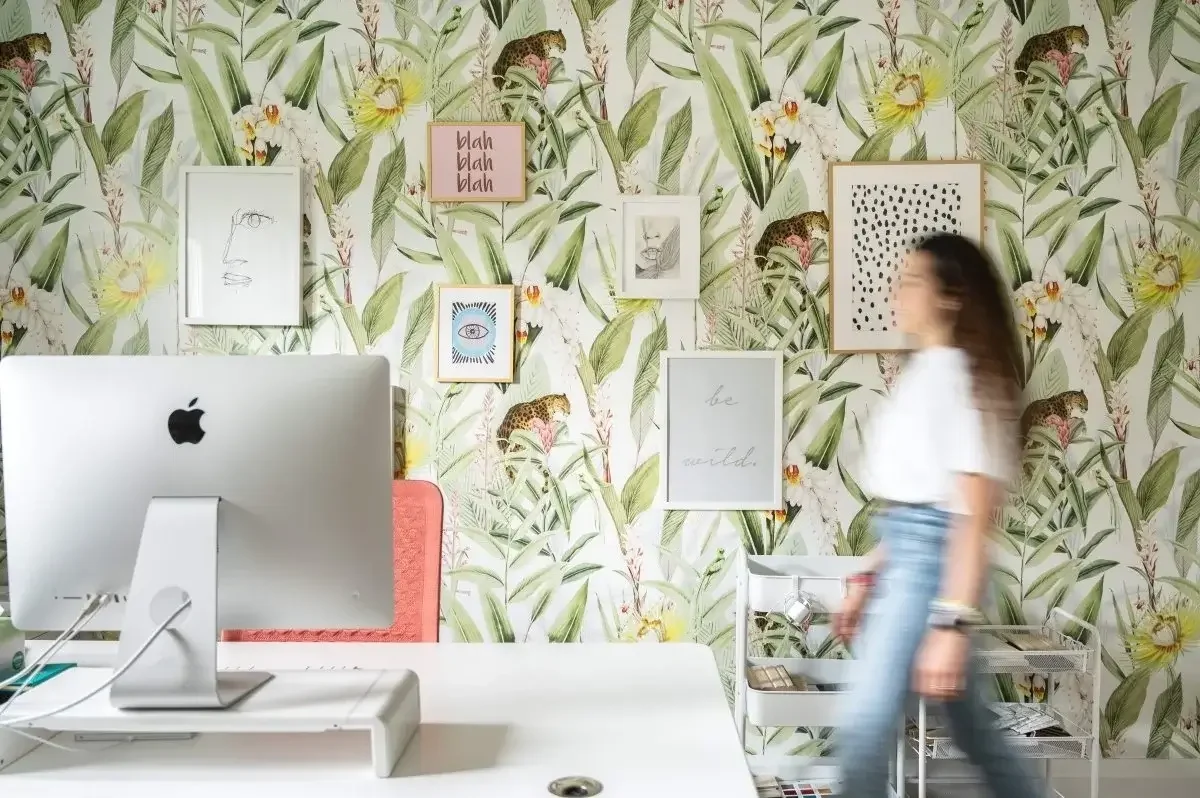 Creative home office interior with bold botanical wallpaper and gallery wall design for modern workspace inspiration