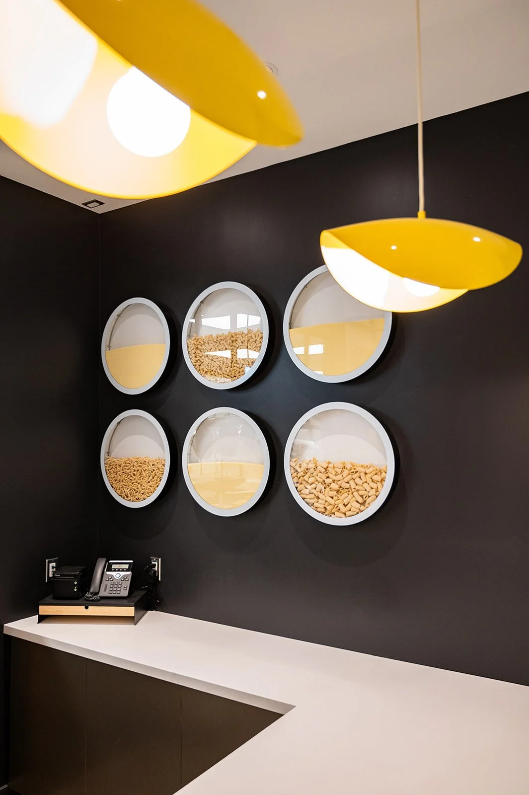 Pasta noodle wall art on matte black wall