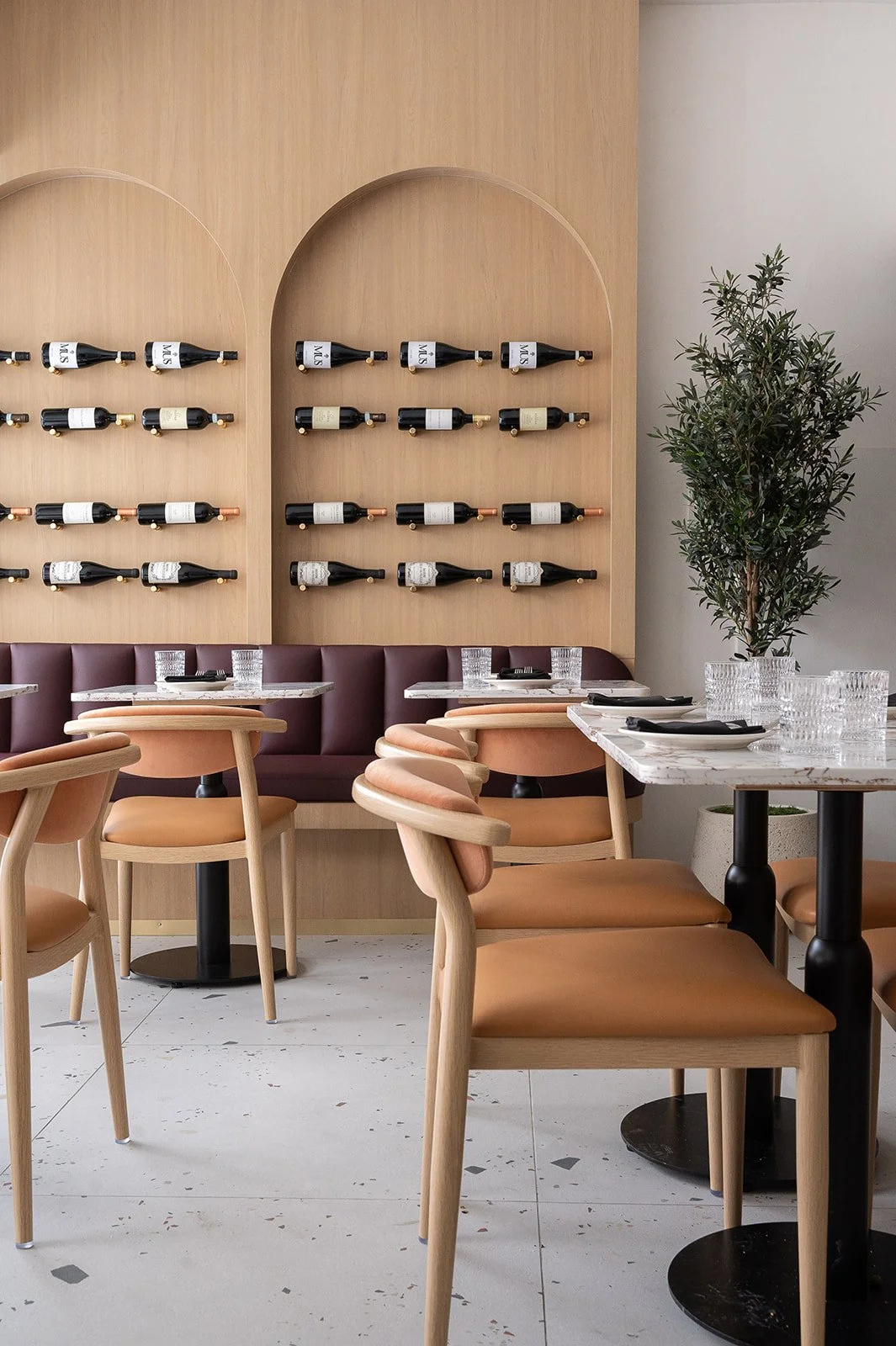 Italian restaurant banquette with wine bottle display above