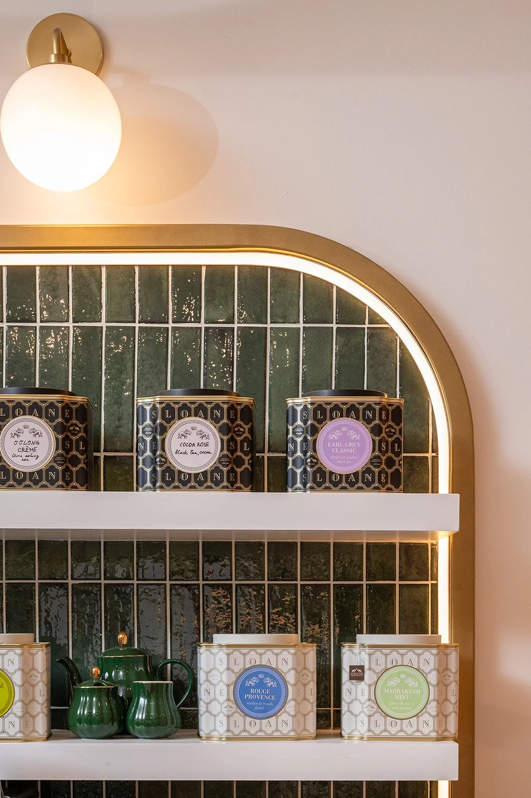 BM Coffee gold signage above green tile brew station with brass faucets and pink cabinetry at Blossom Moments Scotia Plaza