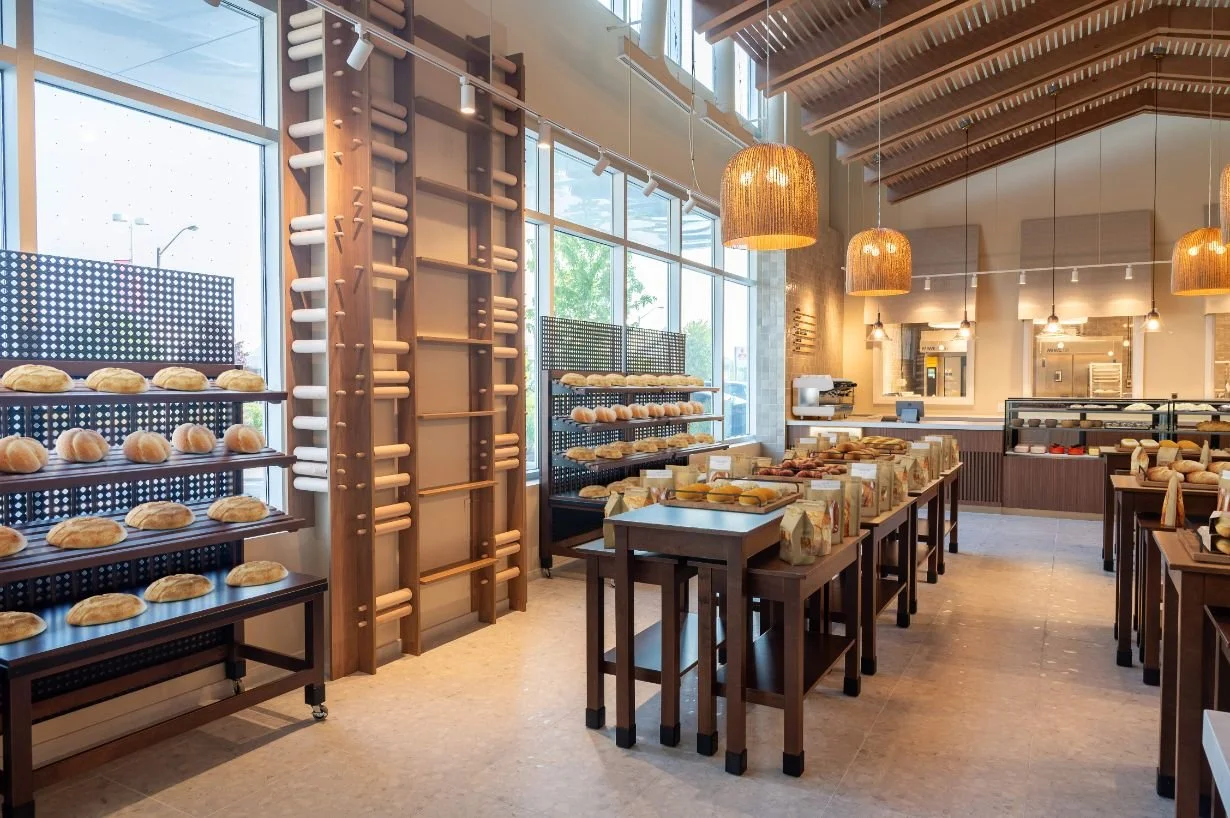 bakery retail shelving displays with overhead wood ceiling canopy and pendant lighting above