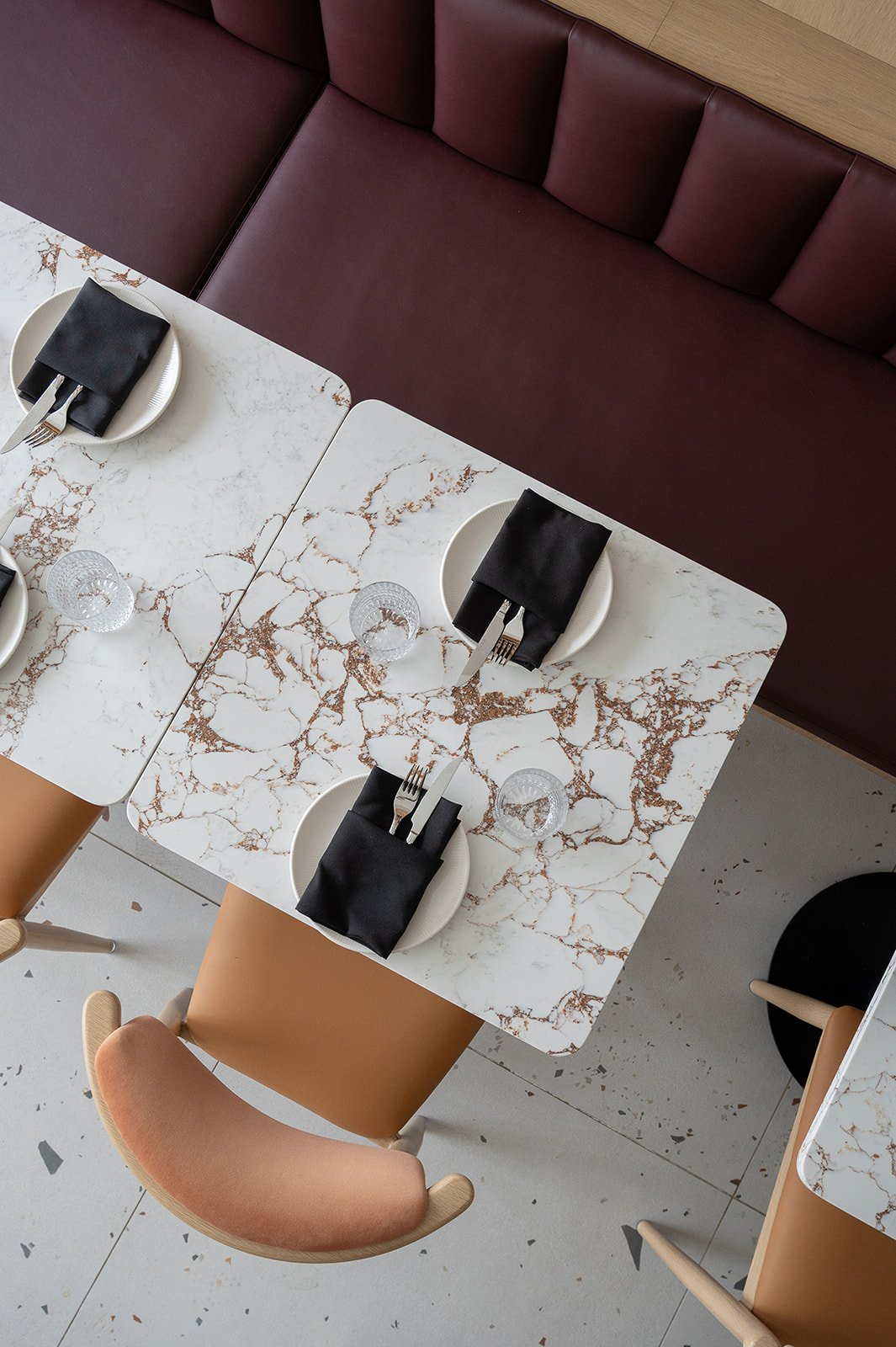 Overhead look at white quartz with gold veining table with 2 place settings