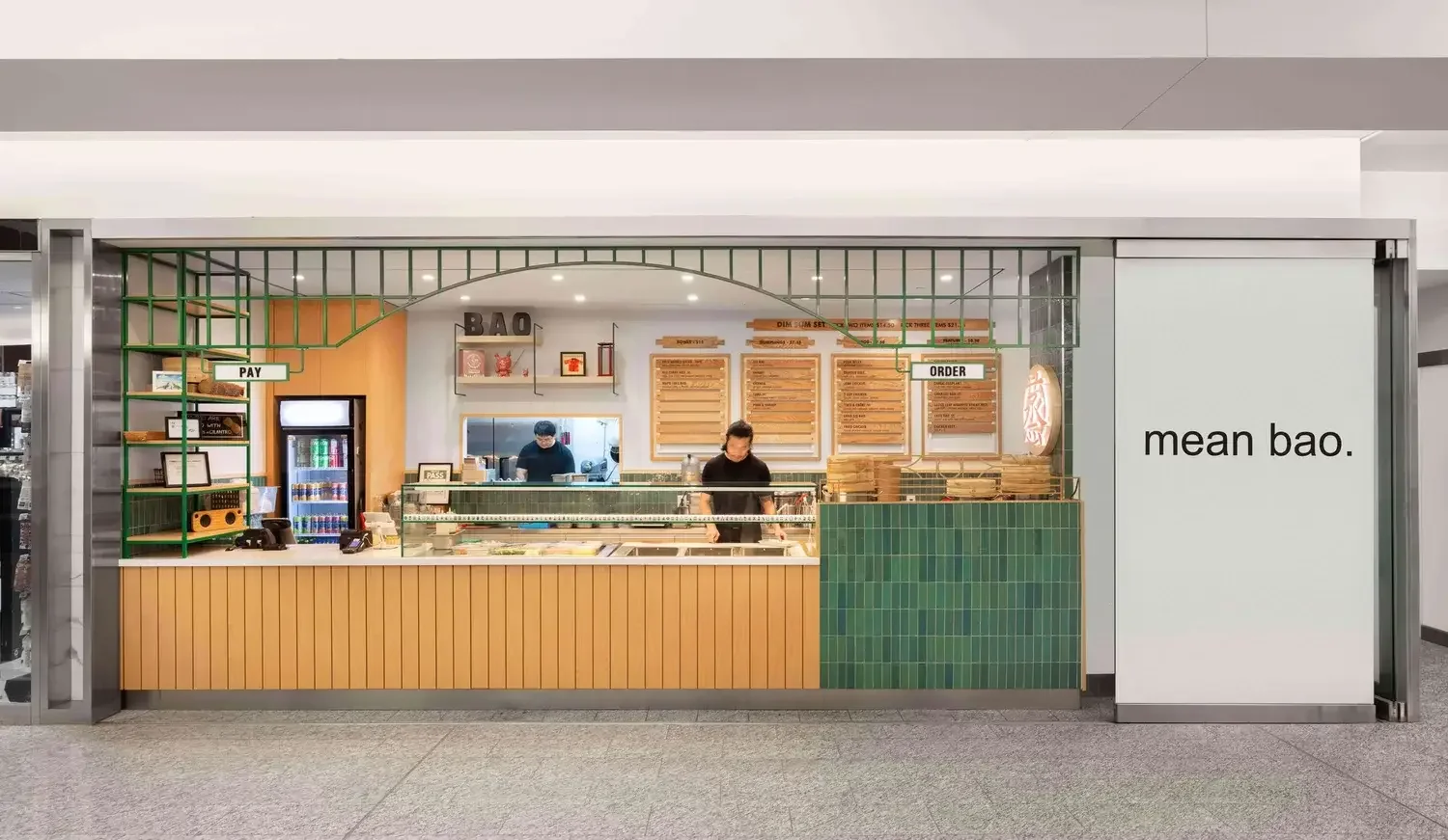 Mean Bao restaurant interior design in Toronto featuring modern takeaway counter, green tile finishes, and efficient service layout