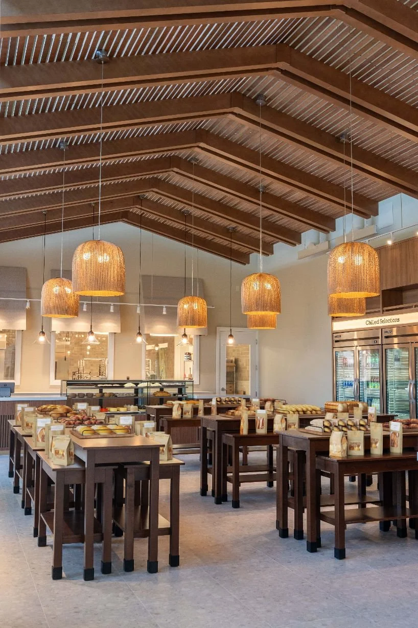 bakery retail shelving displays with overhead wood ceiling canopy and pendant lighting above