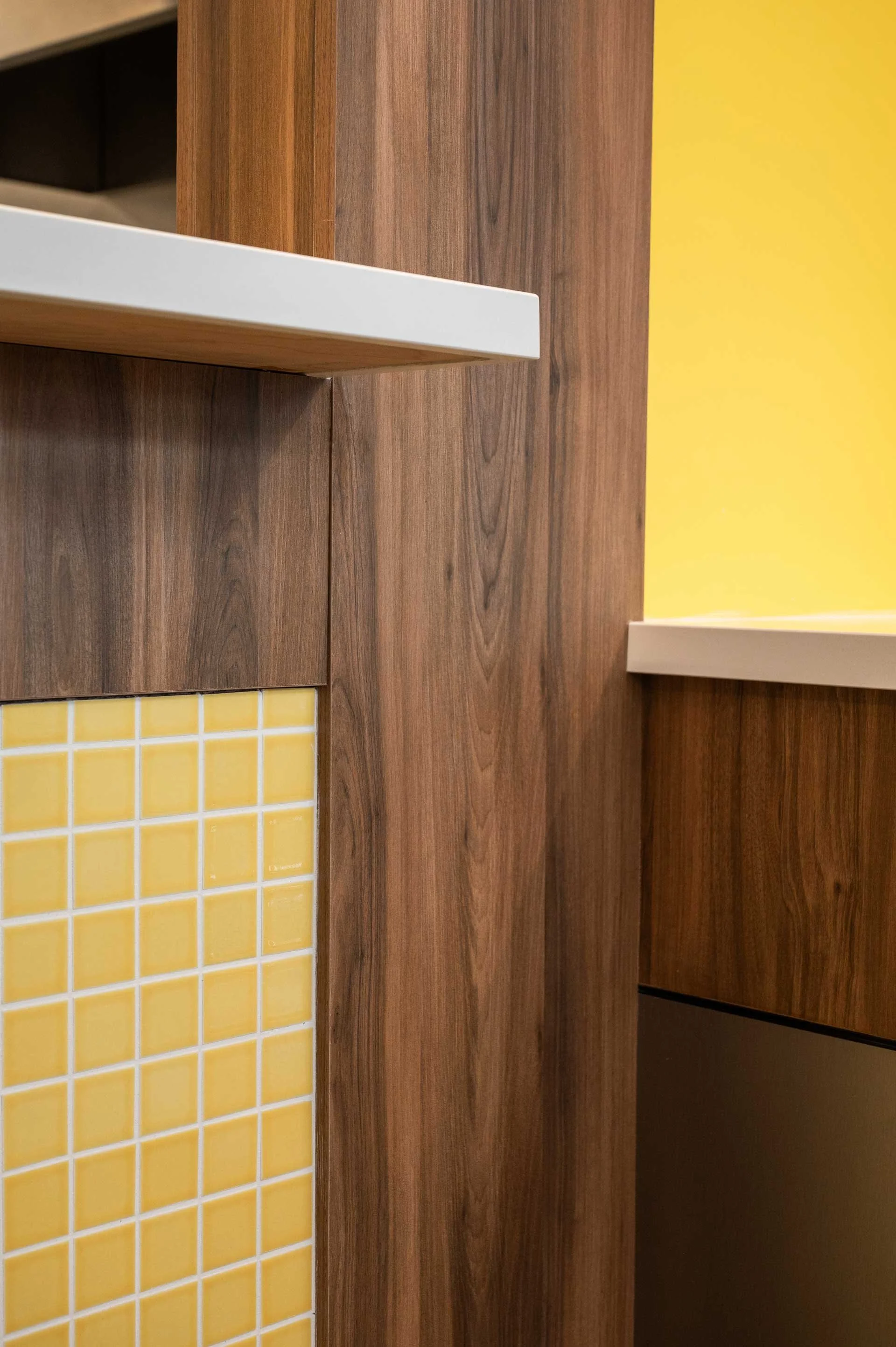 wood clad & yellow mosaic tile wall with stainless steal accent