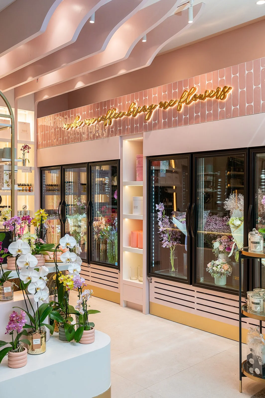 Brass arched display shelving with retail product packaging at Blossom Moments Scotia Plaza