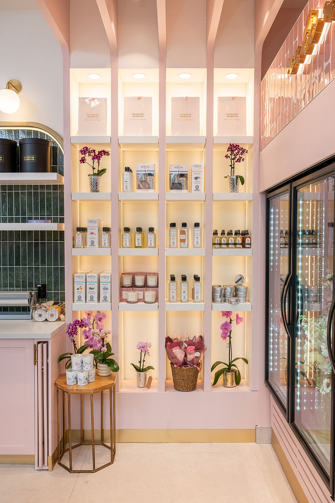 Pink built-in shelving nook with product display and fresh flowers at Blossom Moments Scotia Plaza