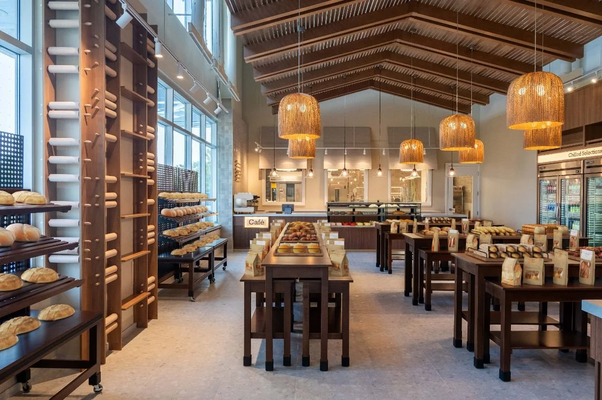 bakery retail shelving displays with overhead wood ceiling canopy and pendant lighting above