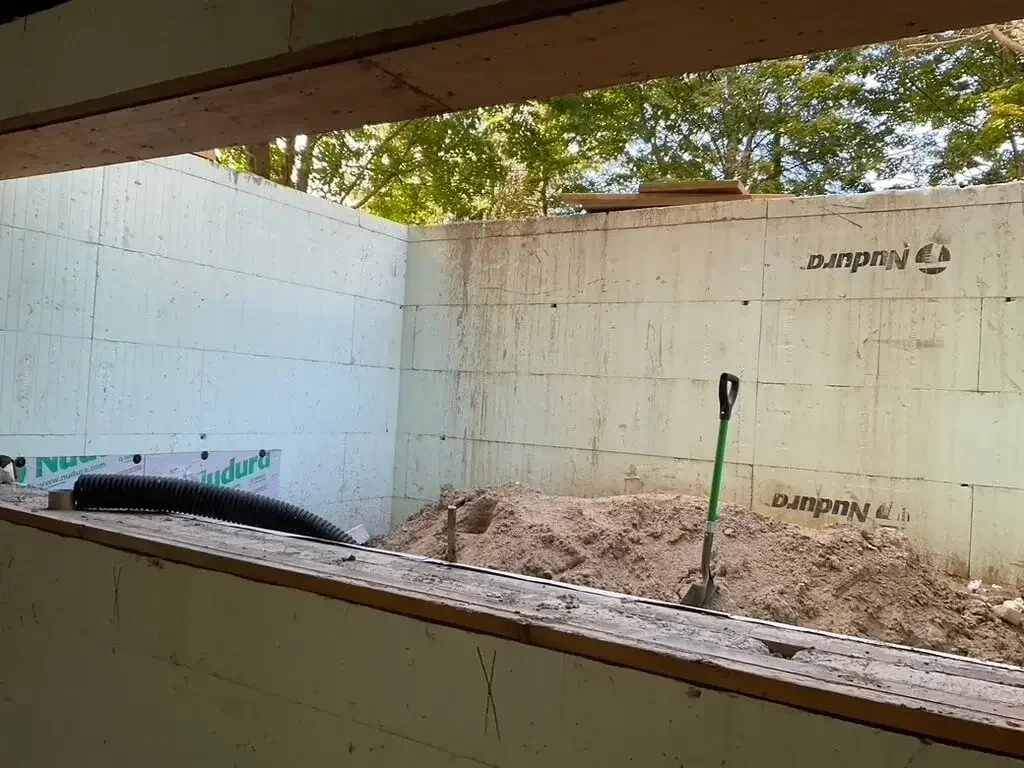 Home renovation construction site with exposed walls, tools, and debris showing early-stage renovation chaos