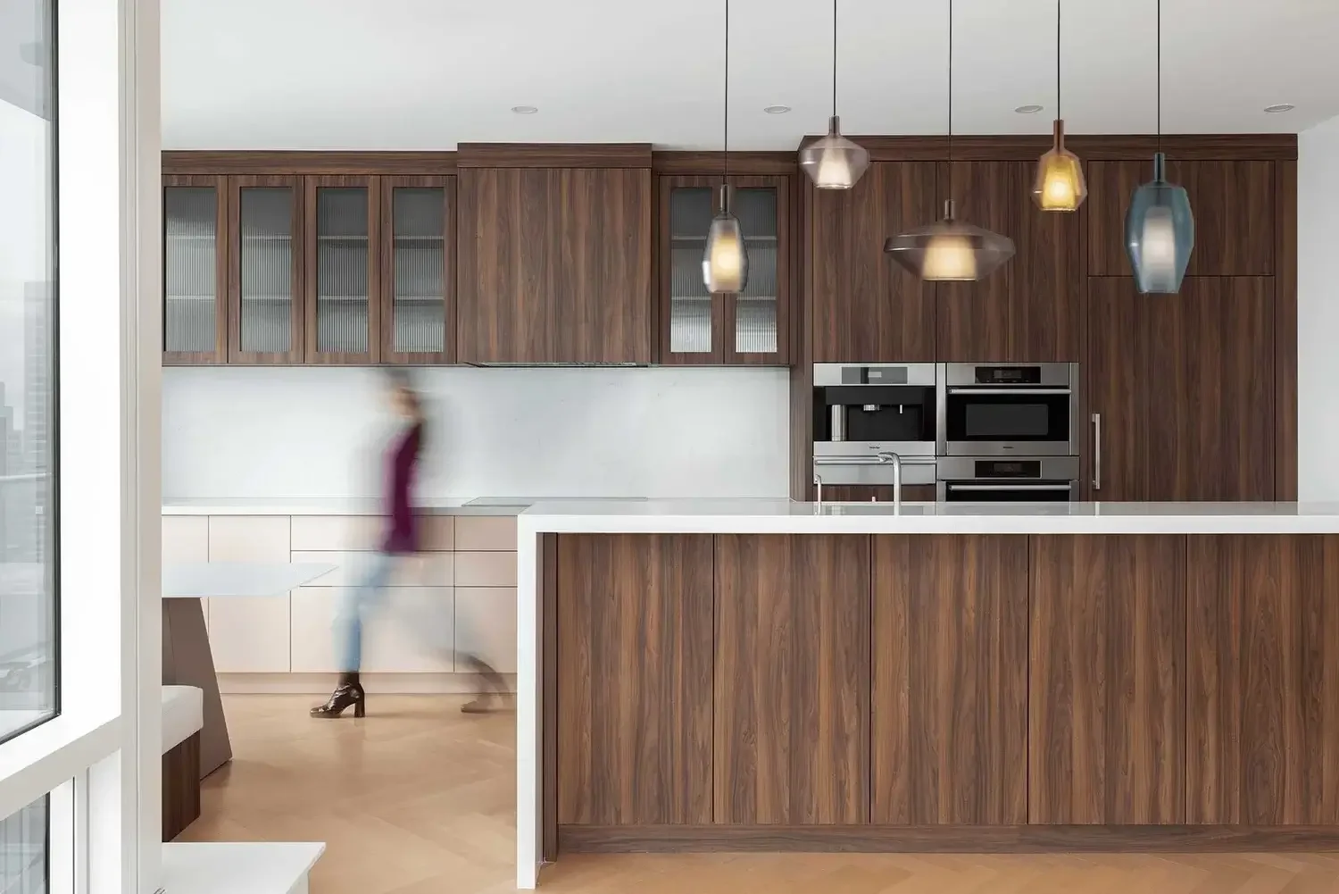 Modern kitchen interior design in Toronto custom home with wood cabinetry, pendant lighting, and open-concept layout