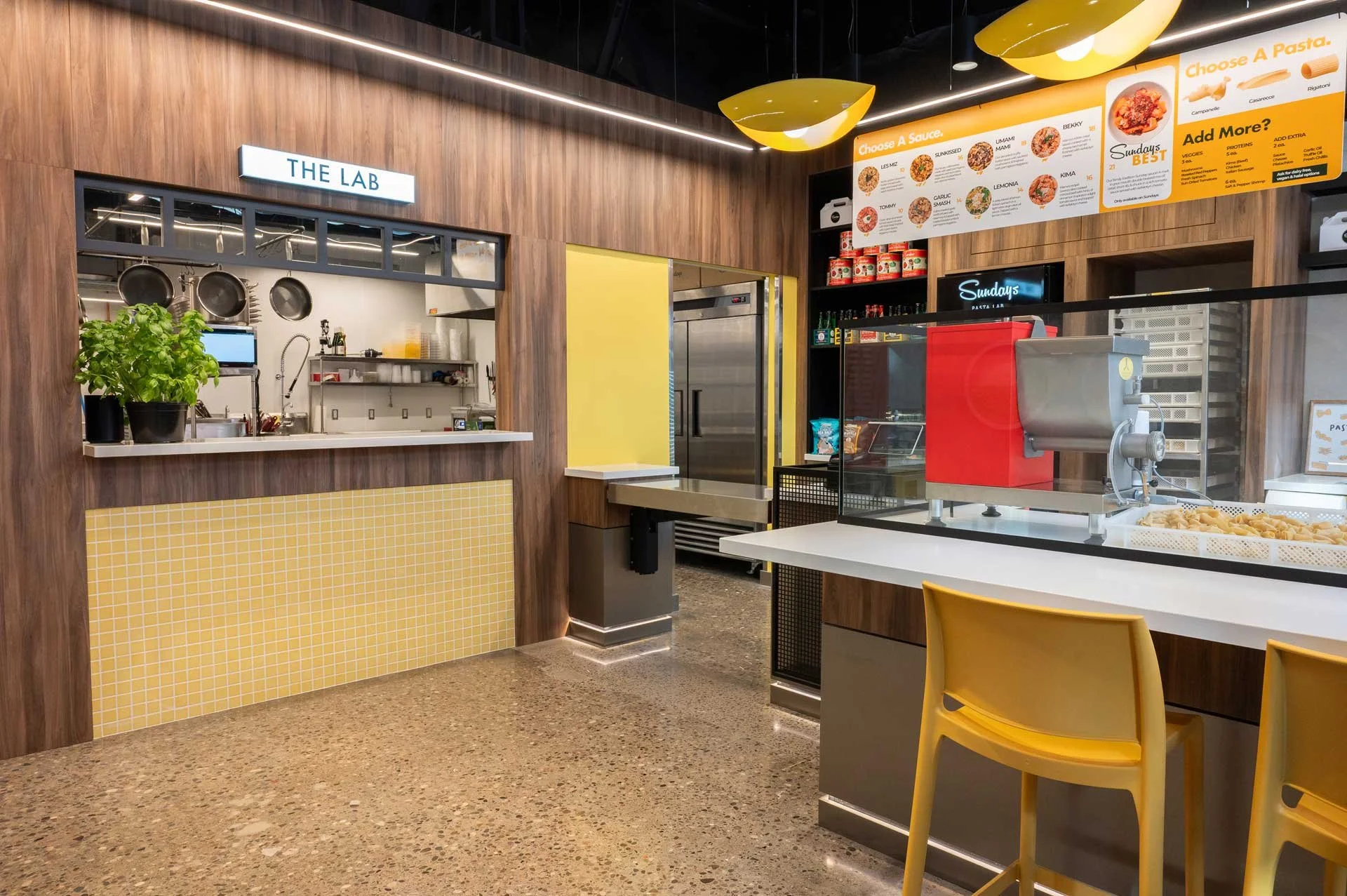 Pasta restaurant interior, concrete floor, wood walls and yellow tile