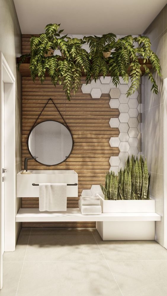 Large natural stone floor tiles compliment hexagonal walls tiles in a bathroom filled with plants