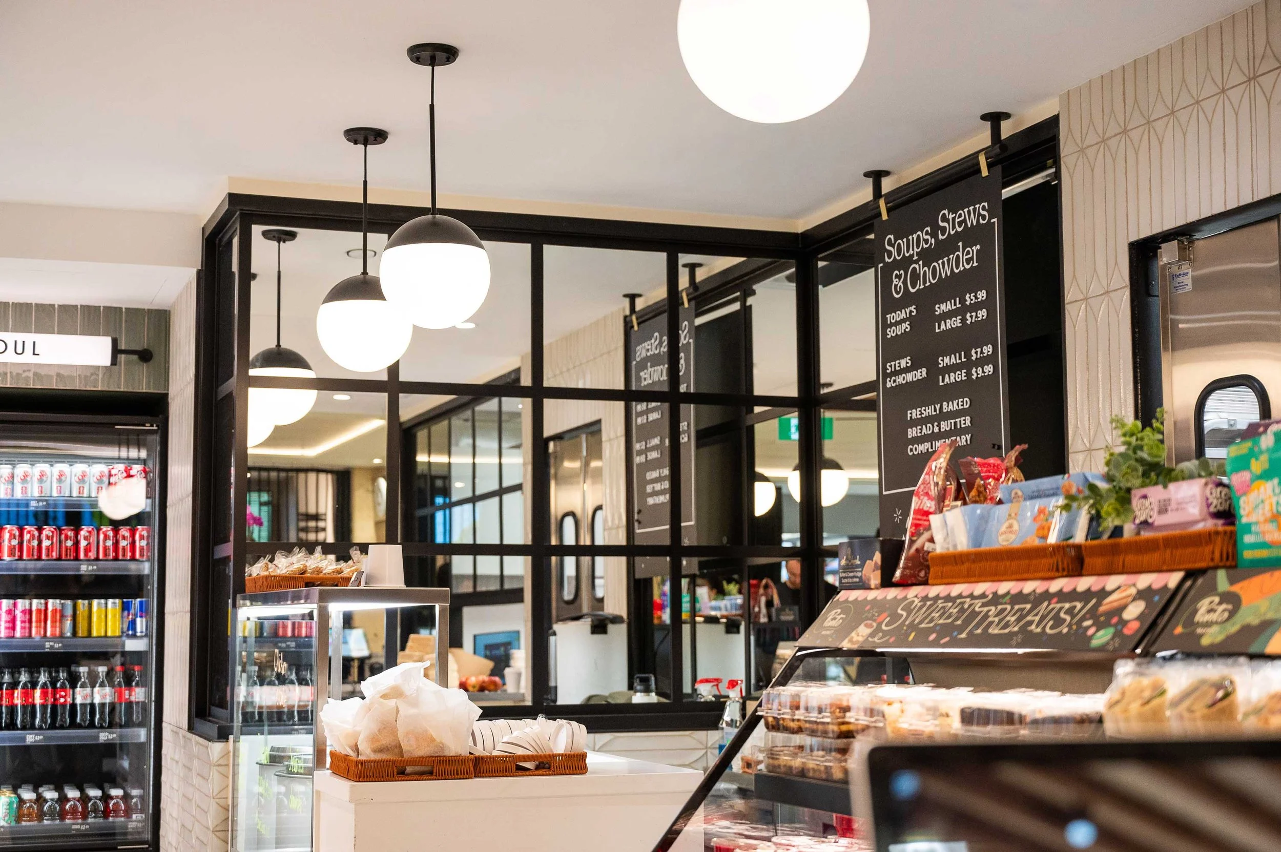 Industrial style window with mirrored panels reflecting market back counter