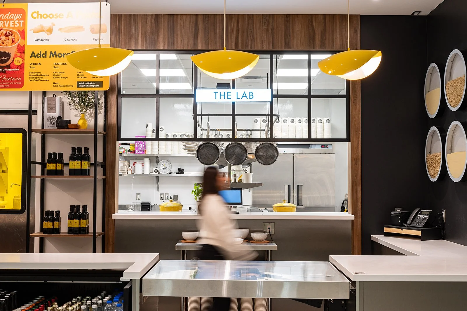 Pasta restaurant service counter with yellow pendant lighting