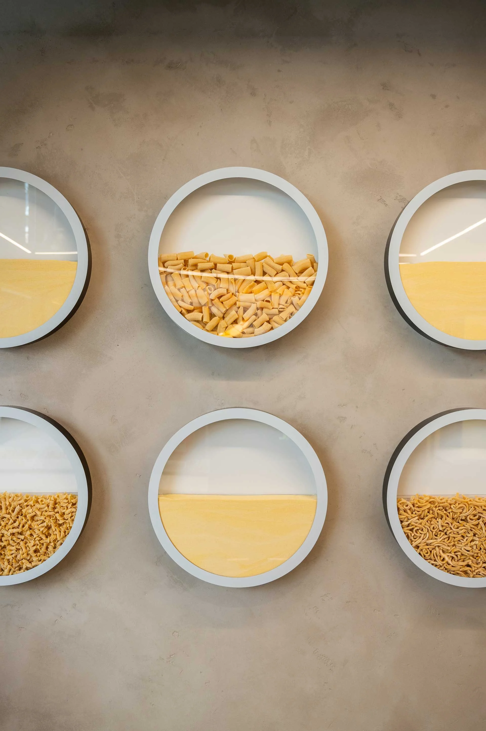 Concrete walls with 6 circular pasta displays