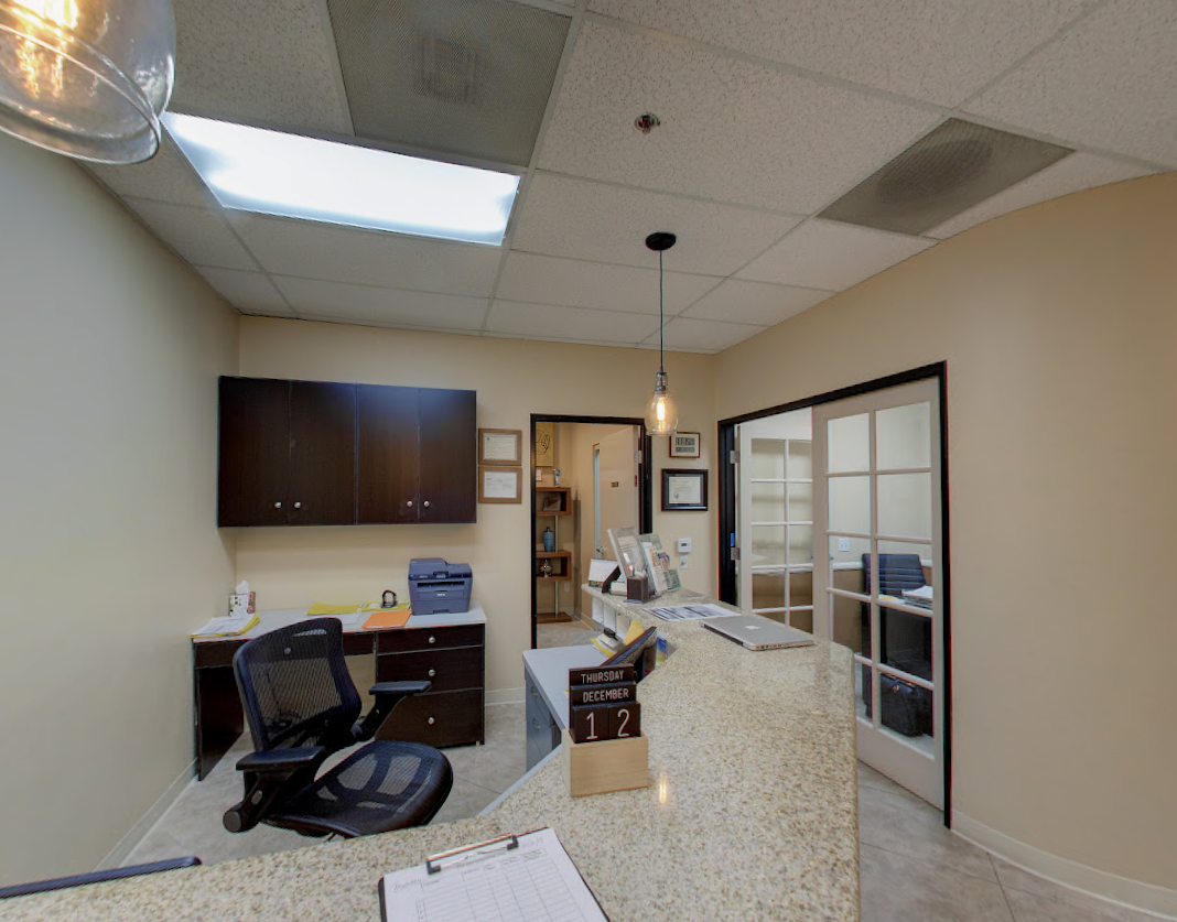 Before photo of the original, outdated medical office space prior to the modern Aliso Dermatology clinic interior renovation.