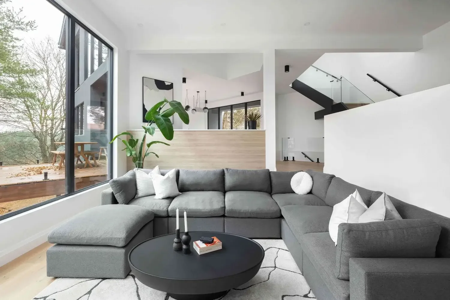 High-end custom home interior design in East Gwillimbury with open-plan living, large windows, and contemporary furniture layout