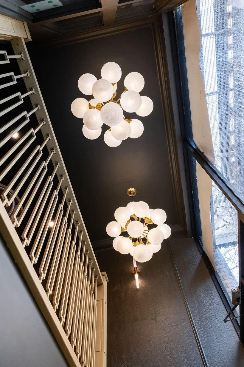 double height ceiling with globe chandelier