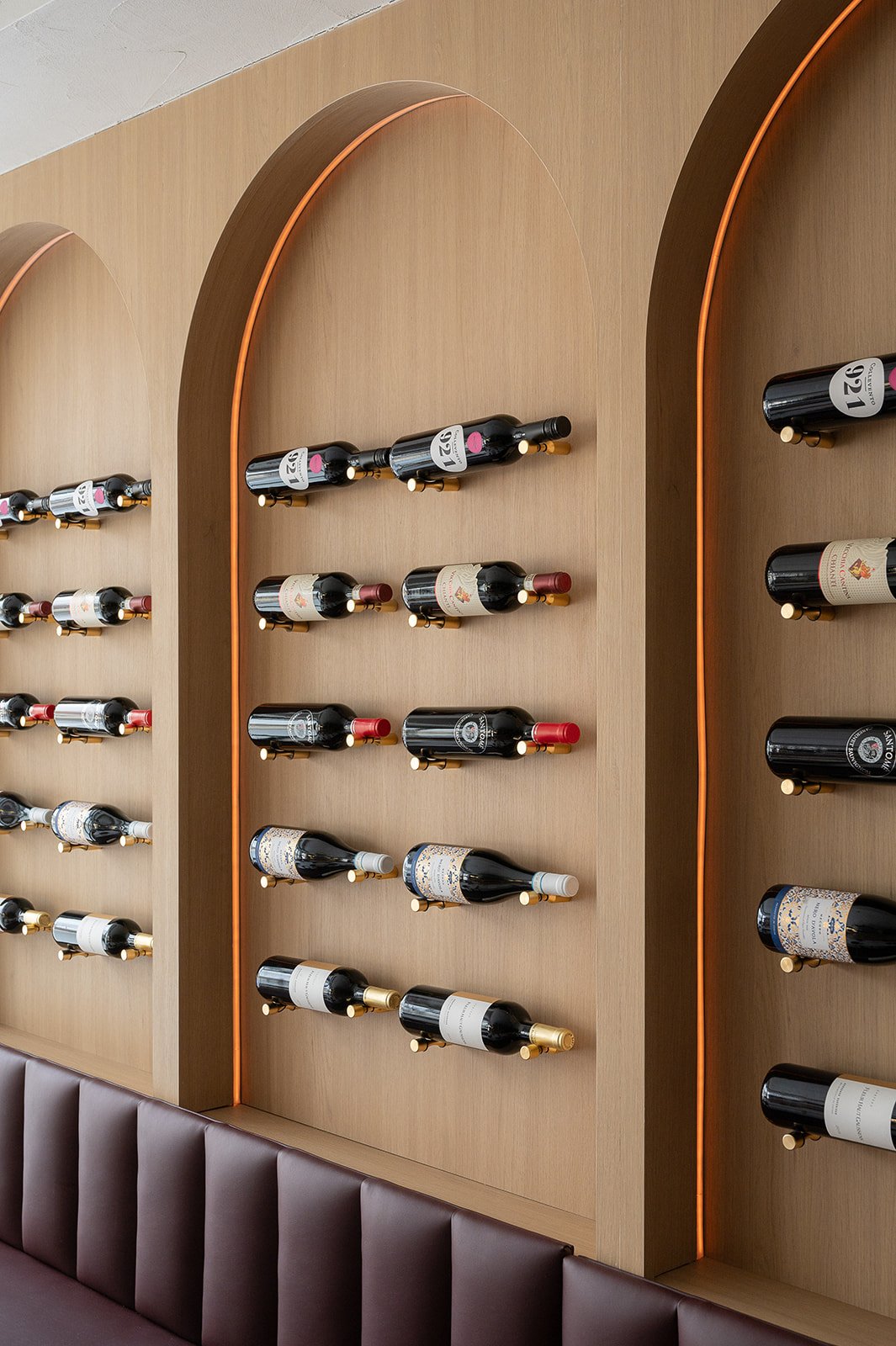 Wine bottle display in arched millwork