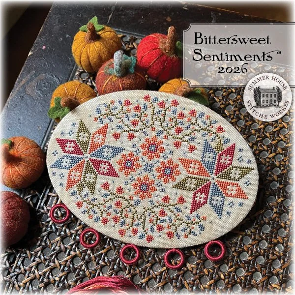 Cross stitched oval floss board with bittersweet vine and star motifs.