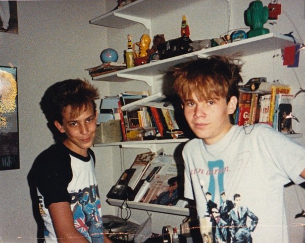  Jonathan &amp; Bill showing off their new bangs. Note OG concert t-shirts and 80’s memorabilia on the shelves.  