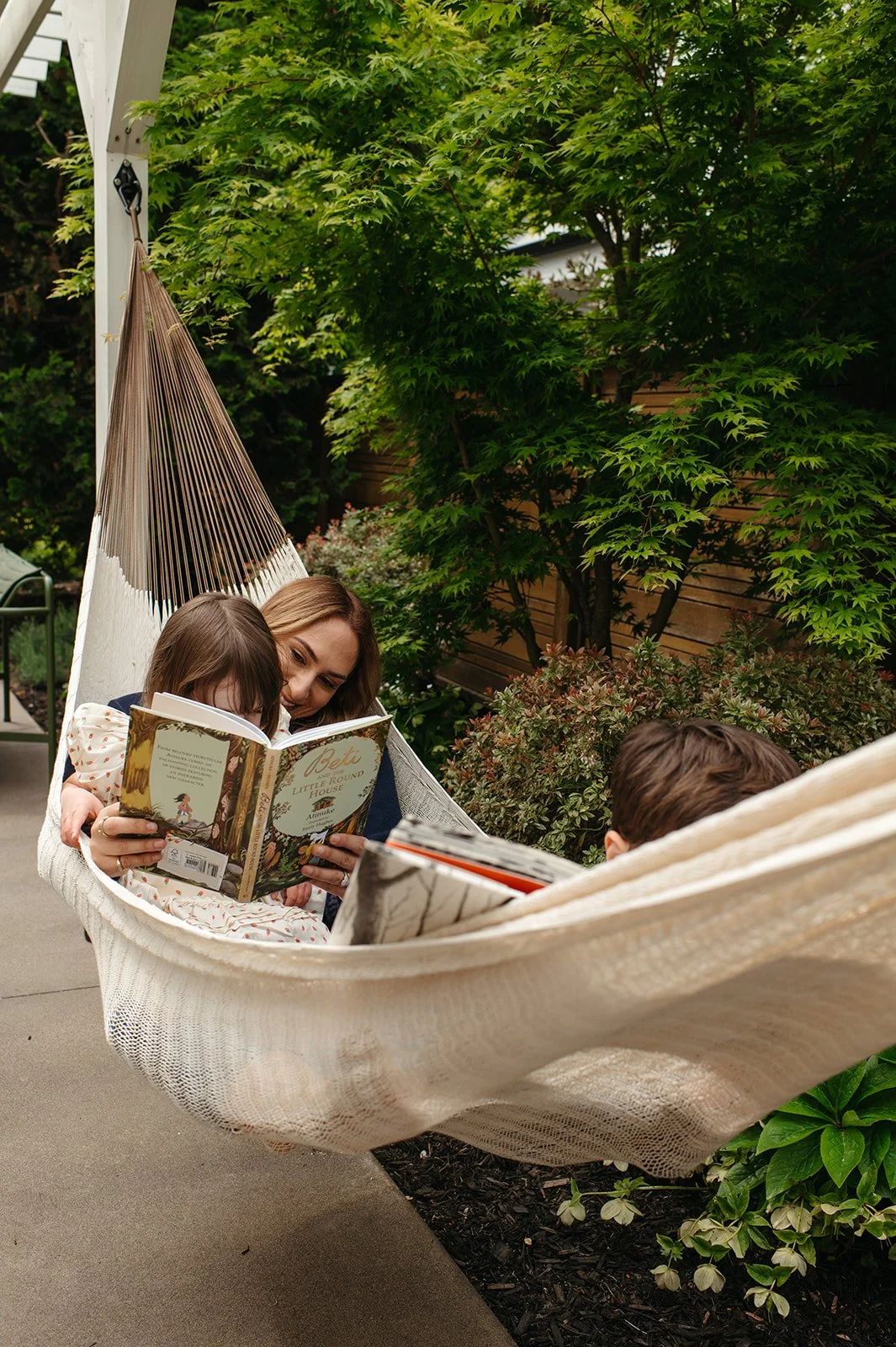 Alison Derse, Realtor Portland Oregon - Alison reading with her child on an outdoor hammock