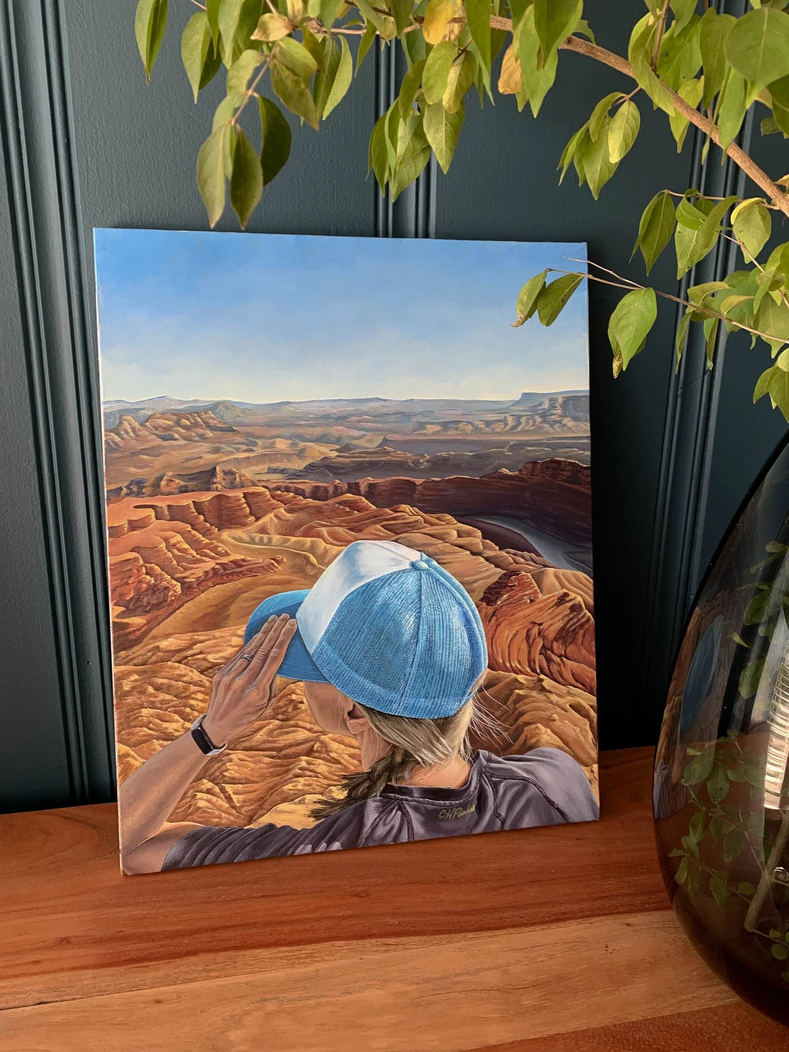Room to Breathe is an oil painting on canvas of a woman in a blue hat overlooking Grand Canyon National Park. It was painted by Chelsea Heresco Parker. (Copy)