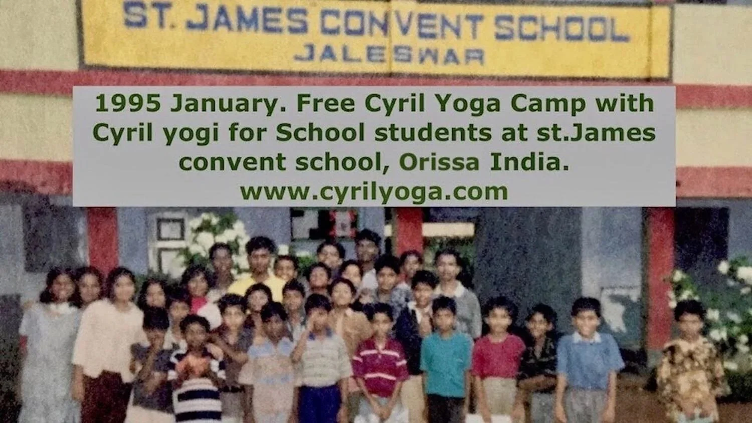 Group of school children and adults standing in front of St. James Convent School in Jaleswar, Orissa, India. A signboard with school information is visible above them.
