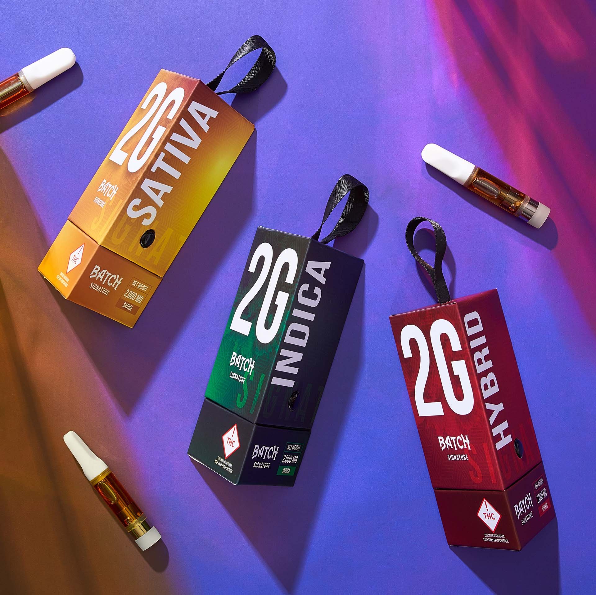 RXD Co - Batch Signature vape carts & packaging x3, overhead with colored gels_.jpg