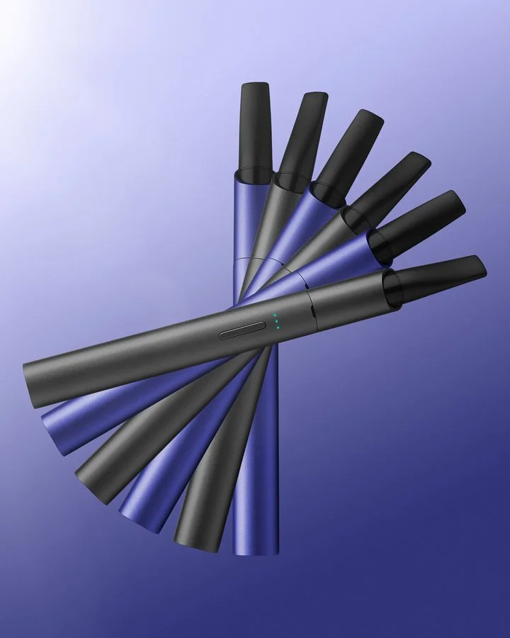 Multiple disposable vape pens arranged in a fanned-out pattern on a gradient purple background.