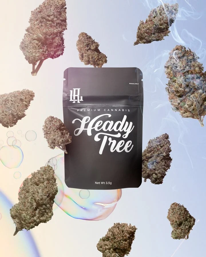 Black resealable cannabis package labeled 'Ready Tree' surrounded by floating cannabis buds with a light rainbow-colored bubble surface background.